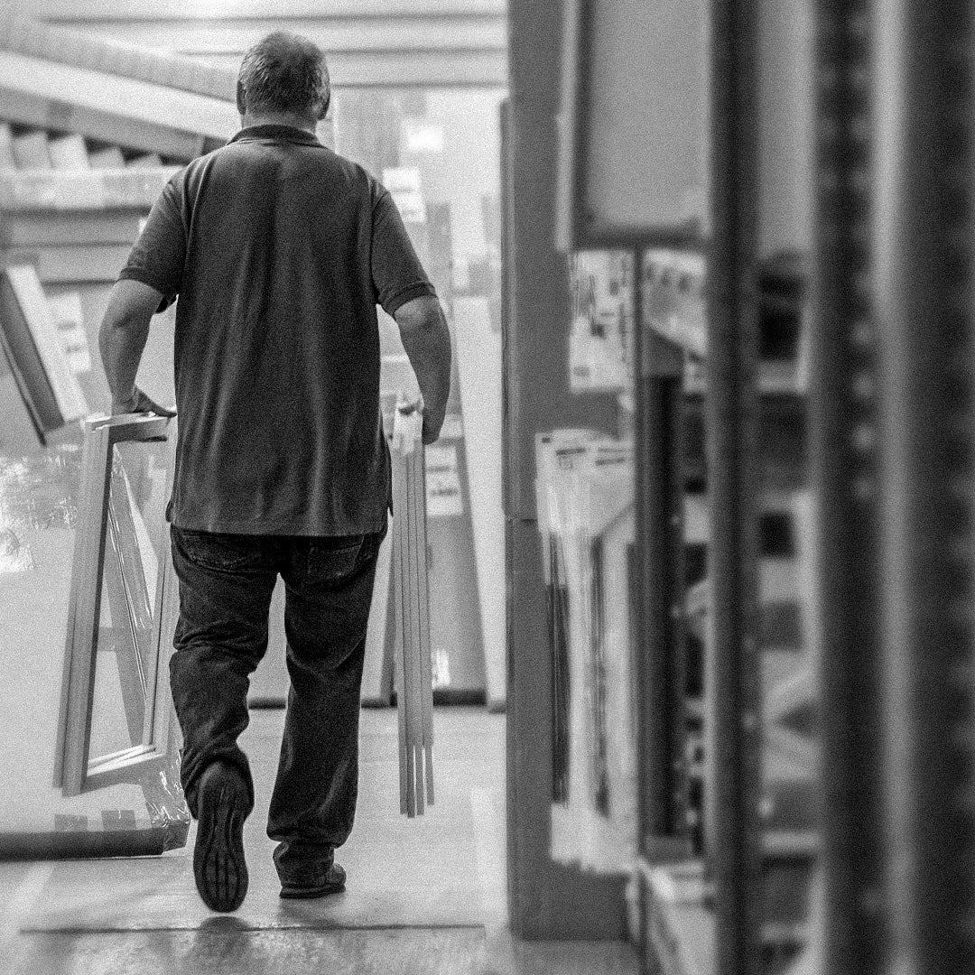 Behind the scenes workshop photography showing handcrafted framing, print finishing and creative production processes. These documentary style images capture the care, detail and craftsmanship behind Quindie’s art prints, framed artwork and design led products.