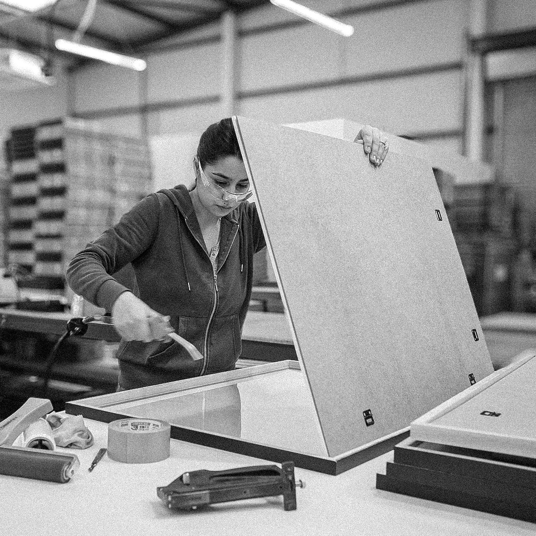 Behind the scenes workshop photography showing handcrafted framing, print finishing and creative production processes. These documentary style images capture the care, detail and craftsmanship behind Quindie’s art prints, framed artwork and design led products.